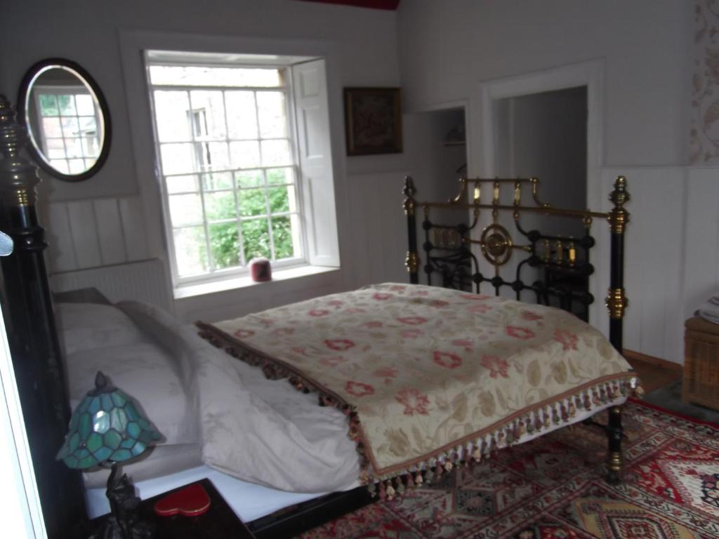 a bedroom with a bed and a window at Manor House Annex - Sleeps up to 6 People in Shepton Mallet