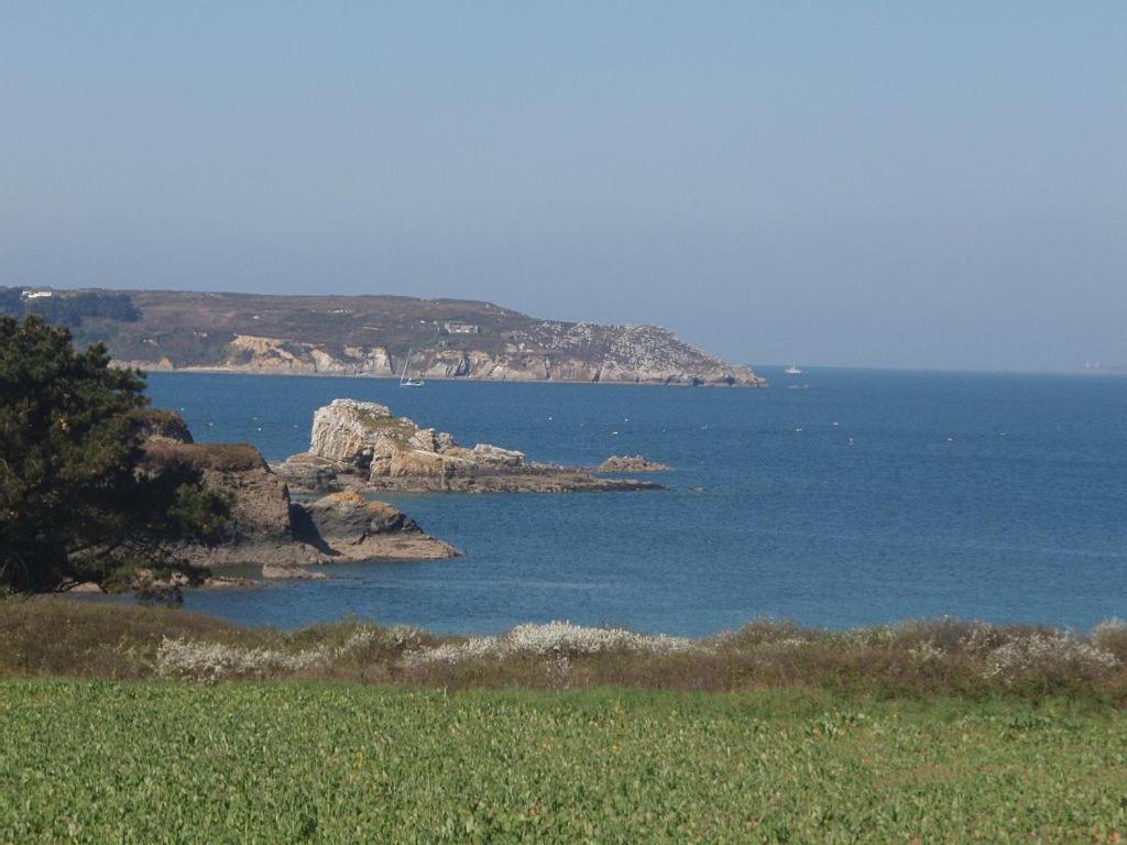 a view of a body of water with rocks in it at les volets bleus in Camaret-sur-Mer