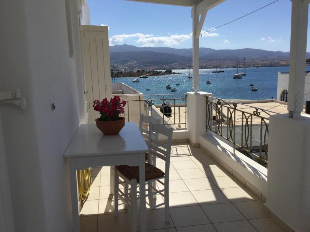 a balcony with a table and a view of the water at Aegeo Inn Apartments in Antiparos Town