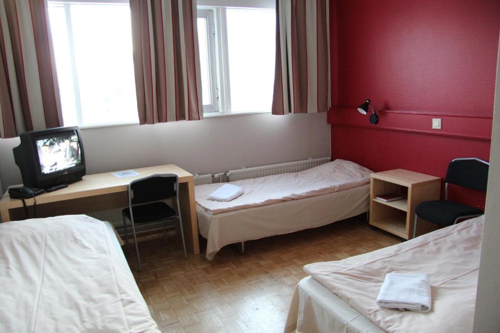 Vuode tai vuoteita majoituspaikassa Santa's Hotel Rudolf