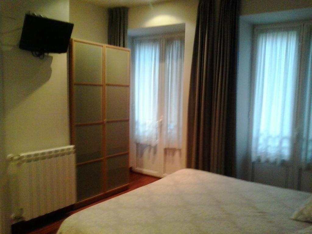 Posteľ alebo postele v izbe v ubytovaní Hostal San Sebastian Centro