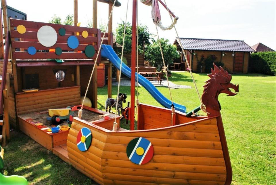 a playground with a pirate ship and a slide at Willa Arletta pokoje i strefa SPA in Jastrzębia Góra