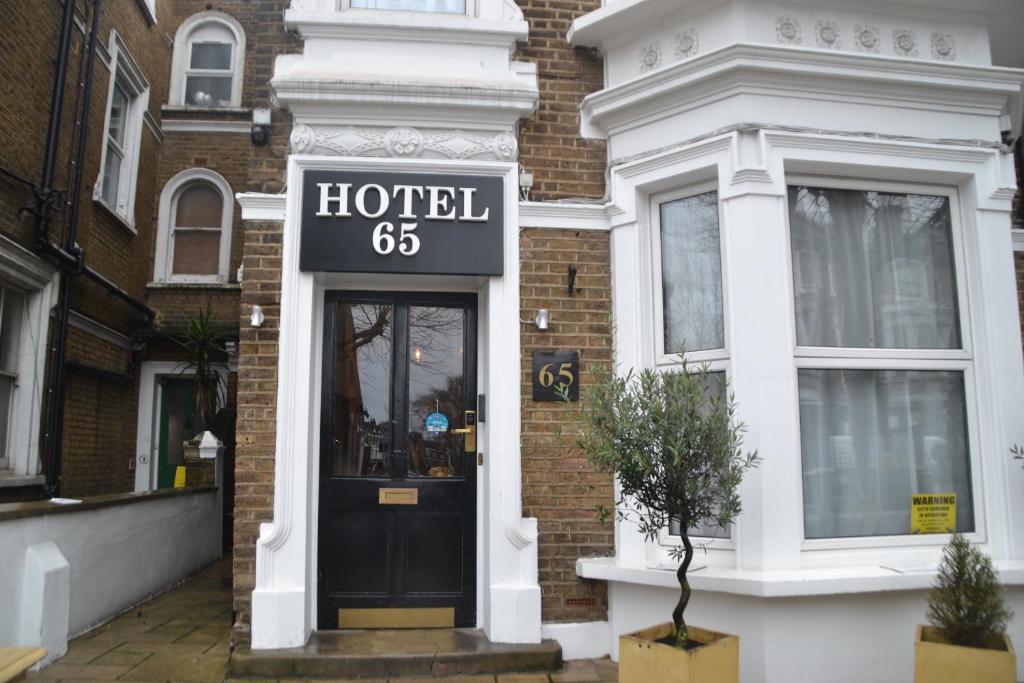 a hotel sign on the front of a building at Hotel 65 in London