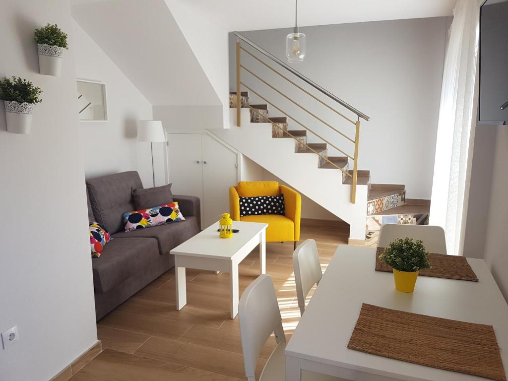 a living room with a couch and a table at Apartamentos Los Corralejos in Fuengirola