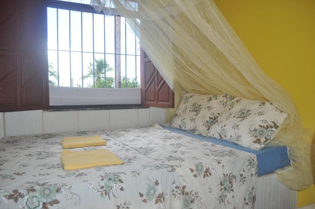 Tempat tidur dalam kamar di Sitiopousada. " Os Tres "