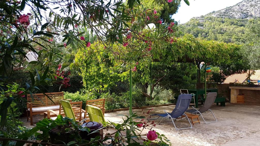 un grupo de sillas sentadas en un jardín en Holiday Home Shangri-La, en Milna