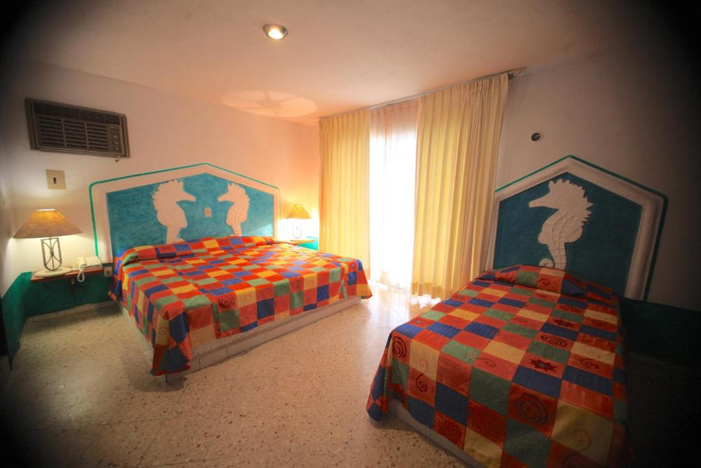 Postel nebo postele na pokoji v ubytování Hotel Carrillos Cancun