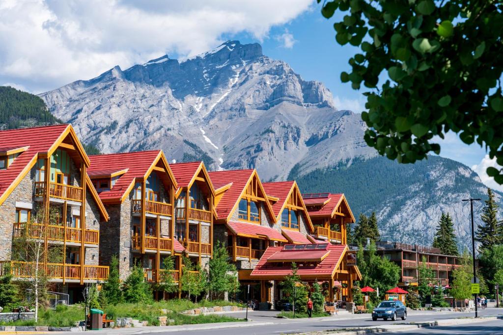 un edificio con techos rojos con una montaña en el fondo en Moose Hotel and Suites en Banff