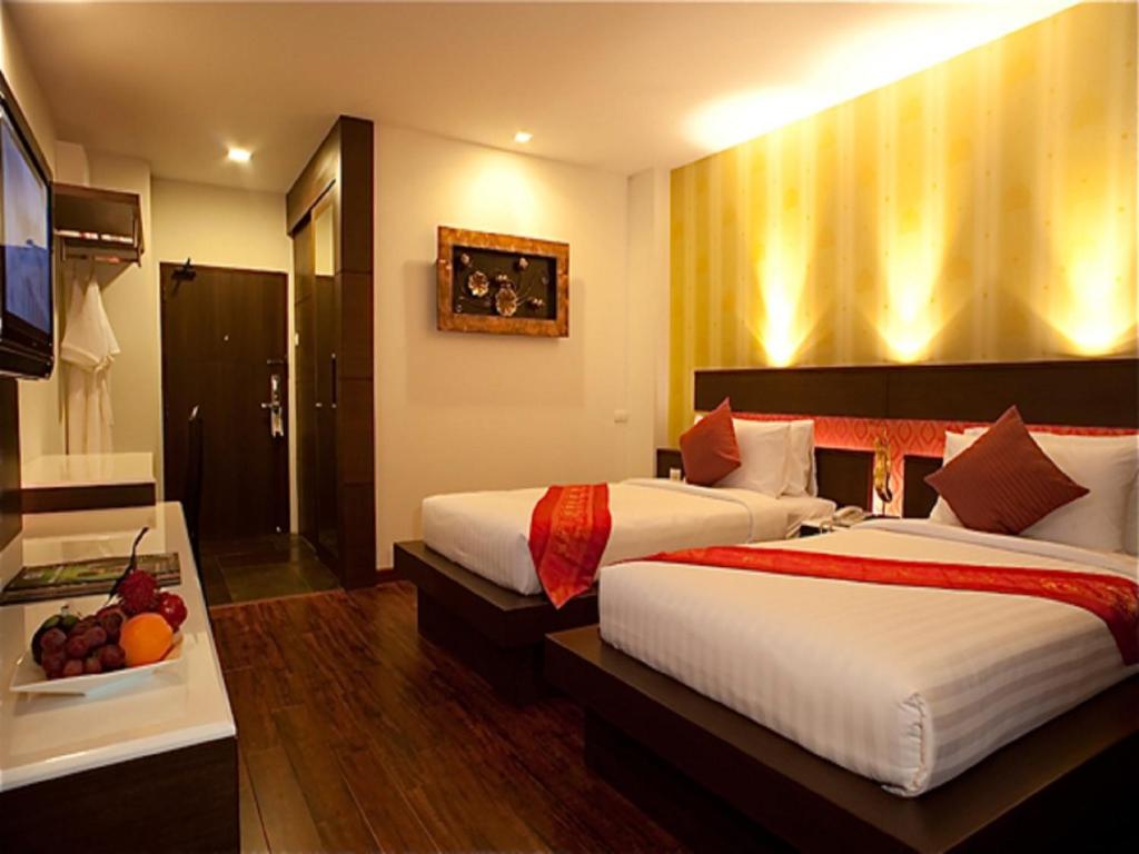 Postel nebo postele na pokoji v ubytování Suvarnabhumi Suite Hotel
