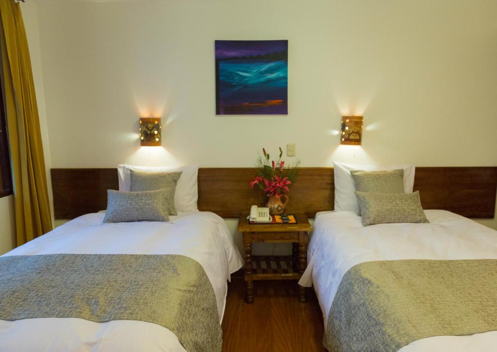 Postel nebo postele na pokoji v ubytování Hotel Rumi Punku