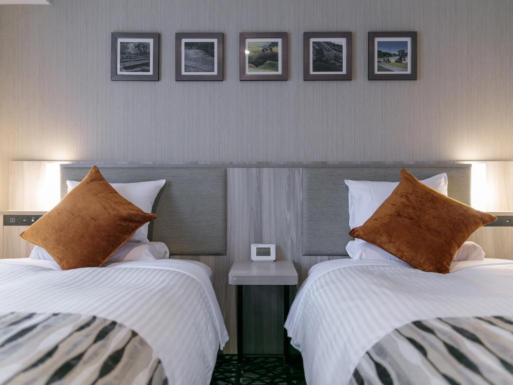 Postel nebo postele na pokoji v ubytování Hotel Mystays Kagoshima Tenmonkan Annex