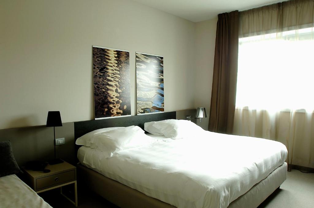 Postel nebo postele na pokoji v ubytování G Hotel Ancona