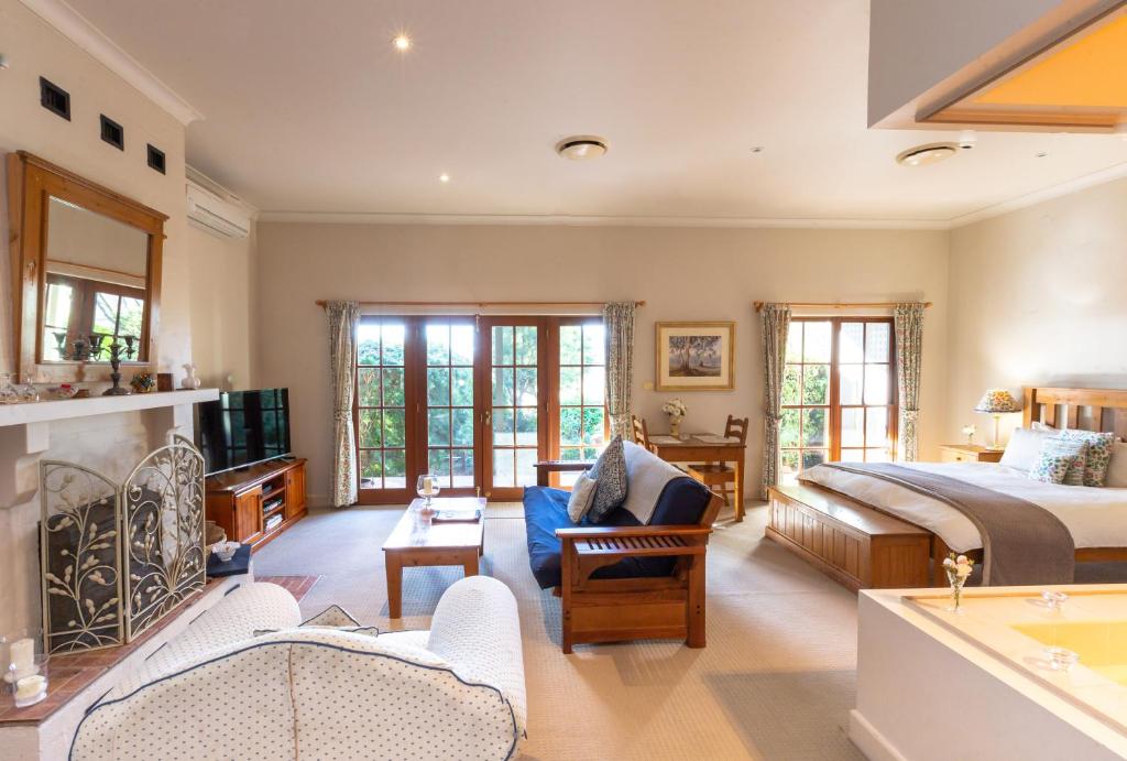 a bedroom with a bed and a living room at Strathearn Park Lodge in Scone
