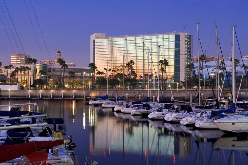 
a marina filled with lots of boats in front of a large building at Hyatt Regency Long Beach in Long Beach
