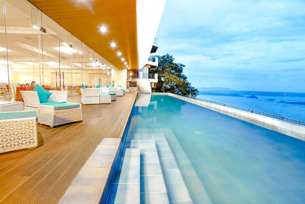 a hotel swimming pool with a view of the ocean at The Lake Hotel Tagaytay in Tagaytay