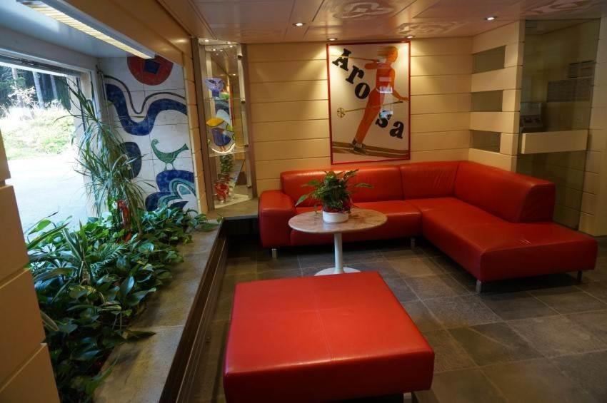 アローザにあるParadies 303の赤いソファとテーブルが備わる待合室