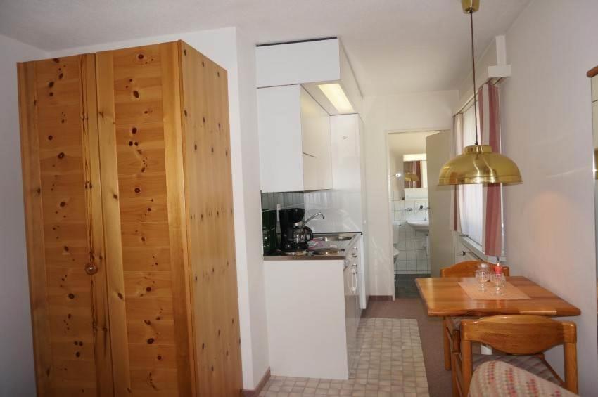 a kitchen and dining room with a table and a dining room at Paradies 503 in Arosa