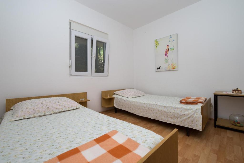 Postel nebo postele na pokoji v ubytování Ilas Dugi Otok