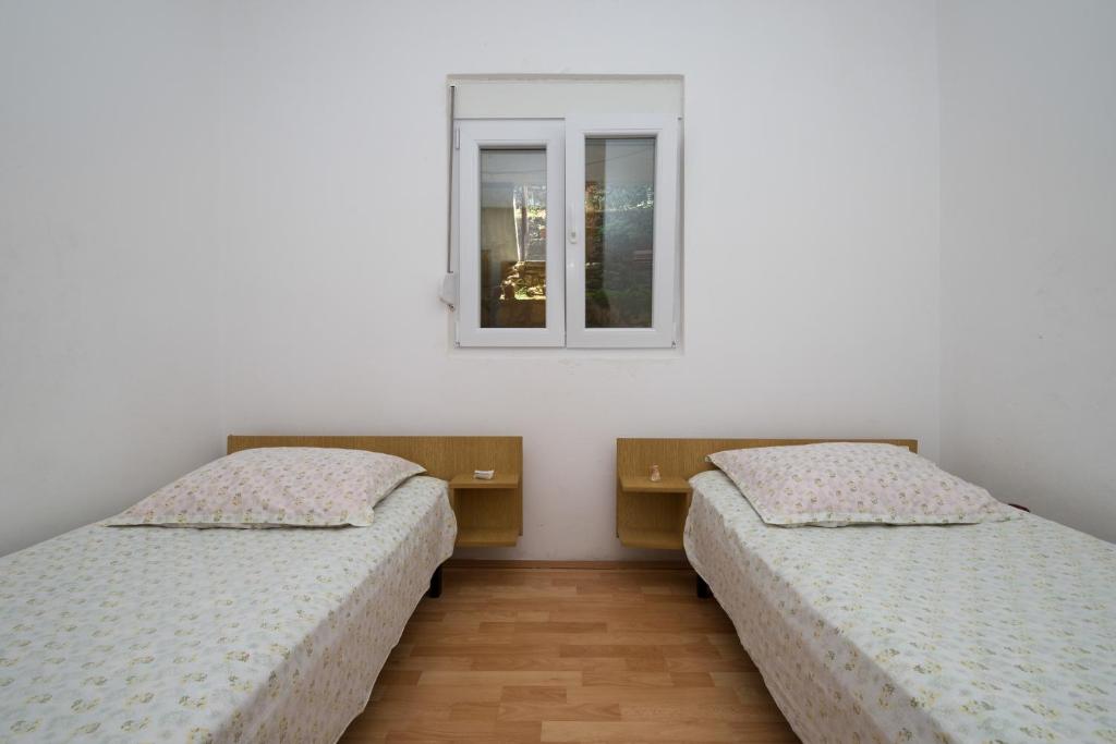 Postel nebo postele na pokoji v ubytování Ilas Dugi Otok