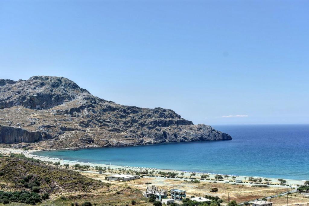 a view of a beach next to the ocean at Sun & Sea Apartments Plakias in Plakias