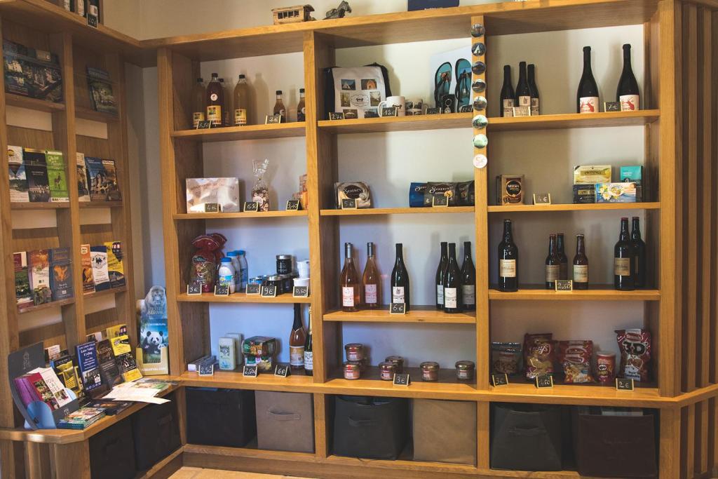 a room with shelves filled with bottles of wine at L&#39;Escale des Châteaux de la Loire in Angé