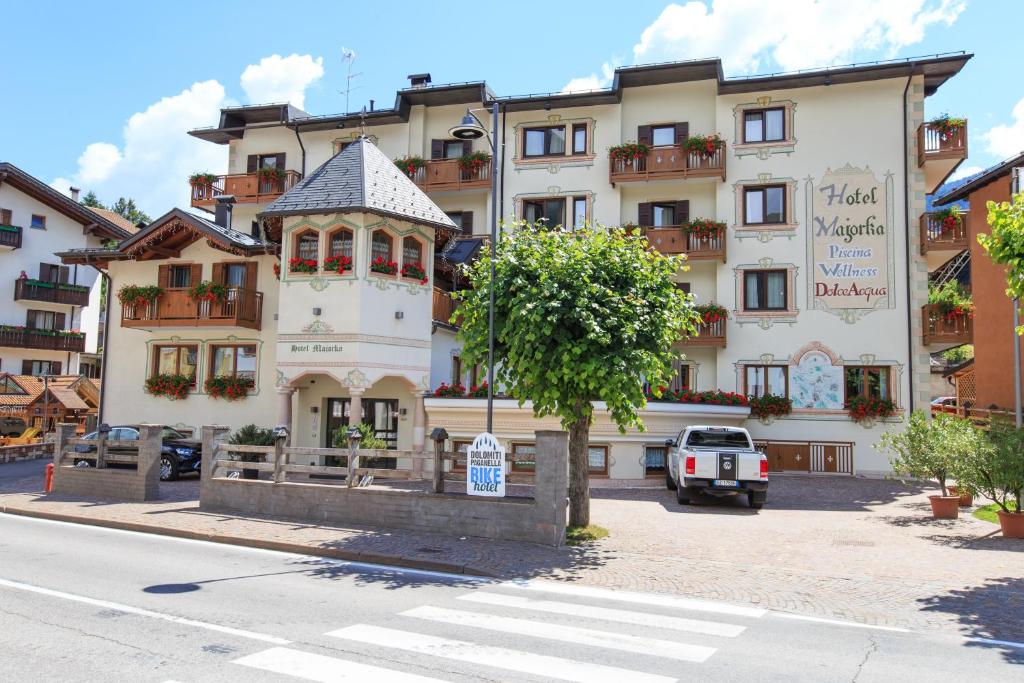 a large building on the side of a street at Hotel Majorka in Andalo