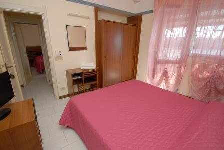 Postel nebo postele na pokoji v ubytování Hotel Baia Del Sorriso