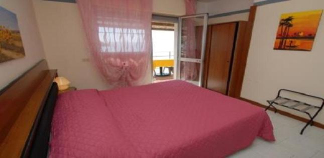 Postel nebo postele na pokoji v ubytování Hotel Baia Del Sorriso