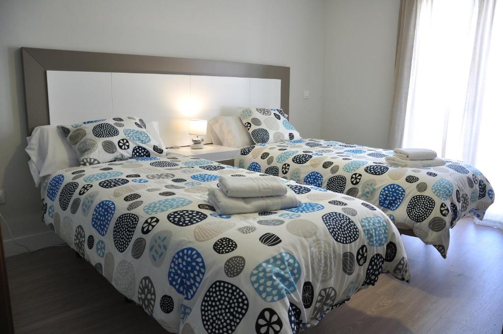 Postel nebo postele na pokoji v ubytování Apartamentos Sábora