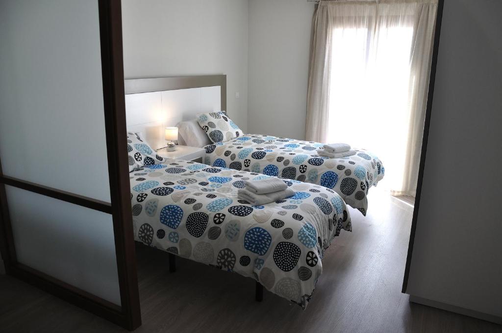 Postel nebo postele na pokoji v ubytování Apartamentos Sábora
