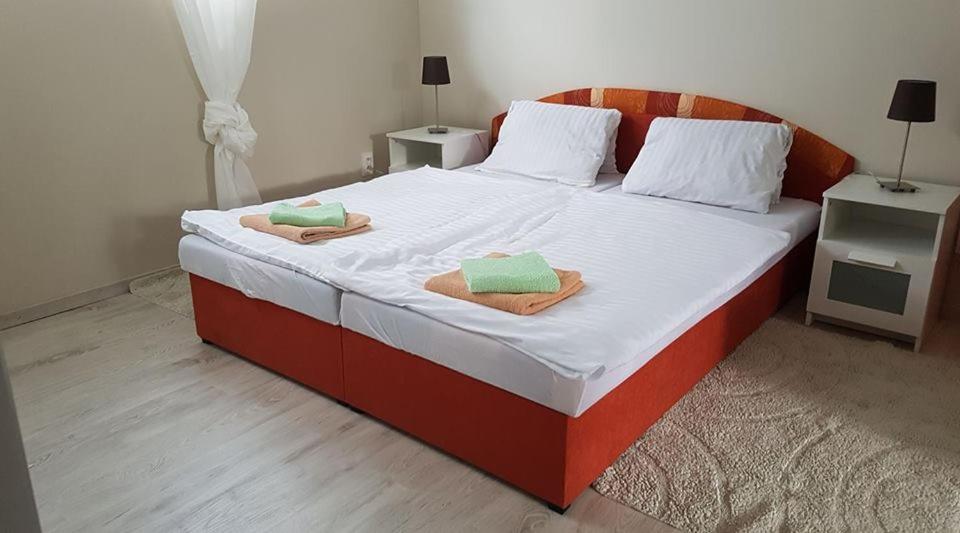 A bed or beds in a room at Penzión KORMOŠ