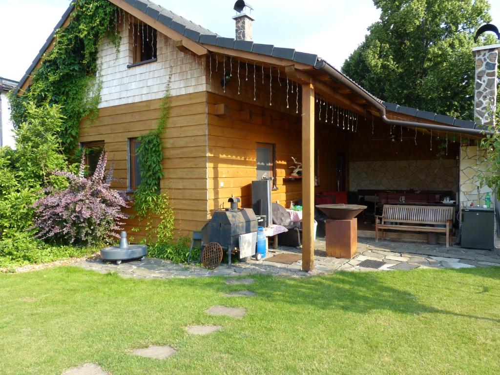 ein Haus mit einer Bank im Hof in der Unterkunft Chatka u šindelára in Liptovský Mikuláš