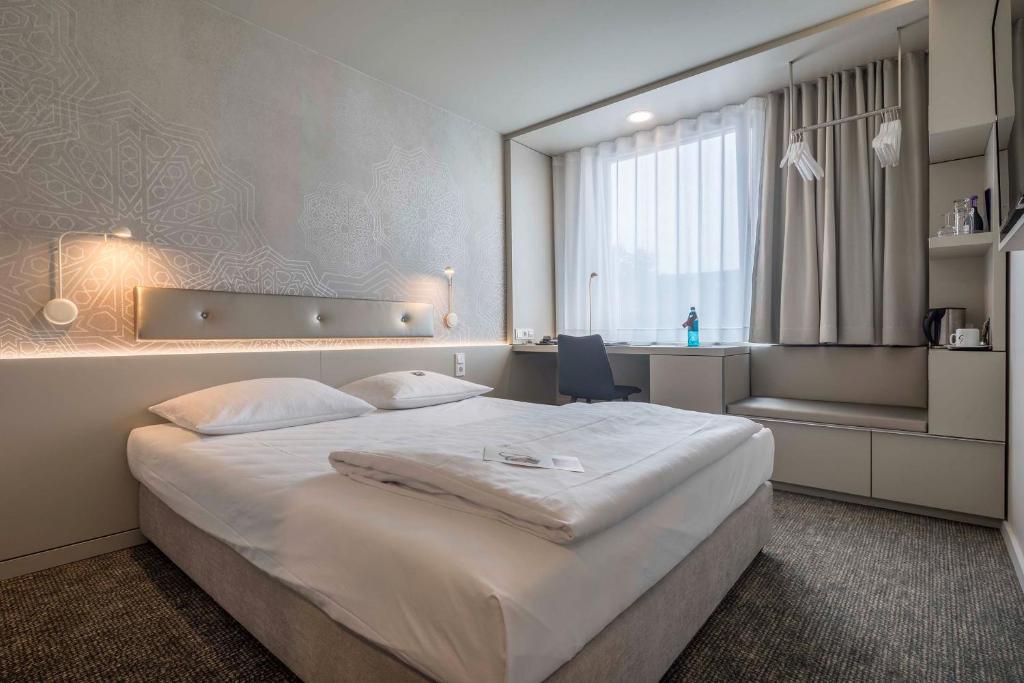 Postel nebo postele na pokoji v ubytování Stadthotel Münster