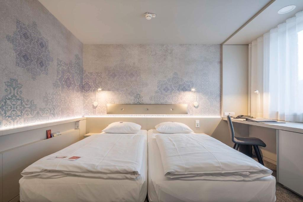 Postel nebo postele na pokoji v ubytování Stadthotel Münster