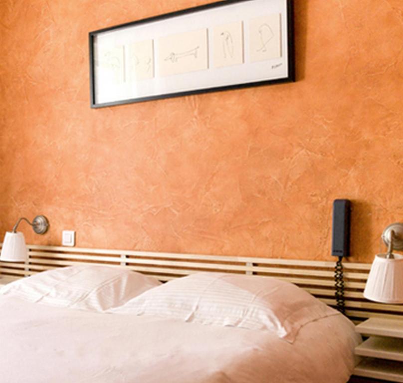 Postel nebo postele na pokoji v ubytování Hotel le Crouesty