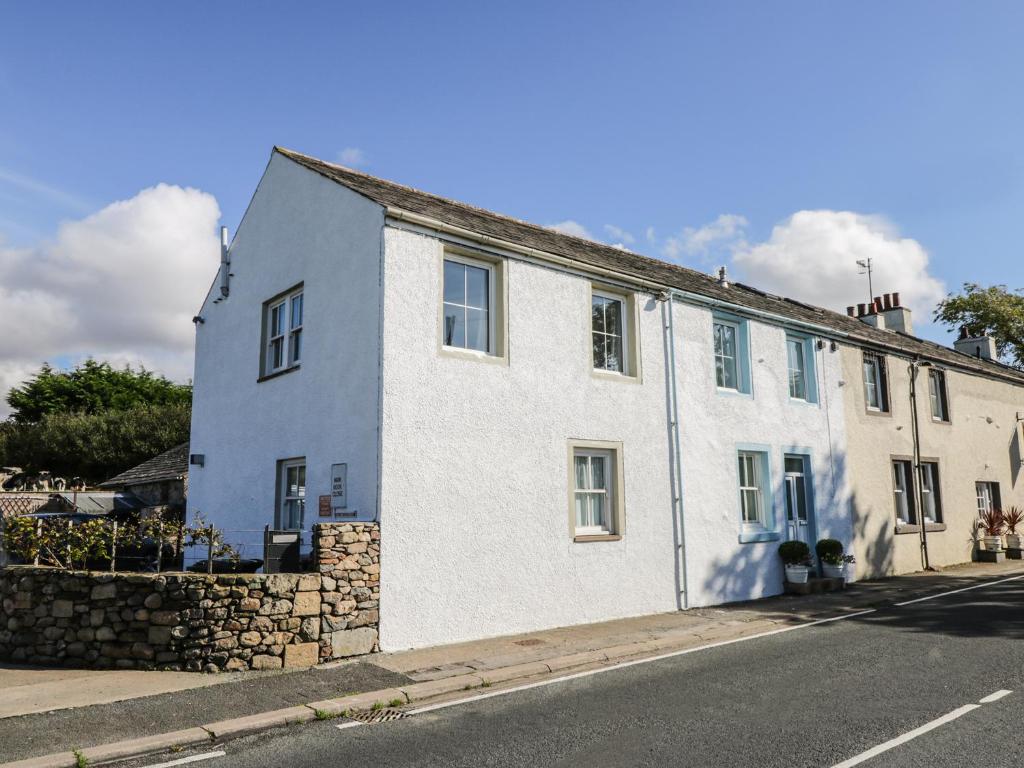 a white building on the side of a street at 1 Park Nook Close in Waberthwaite