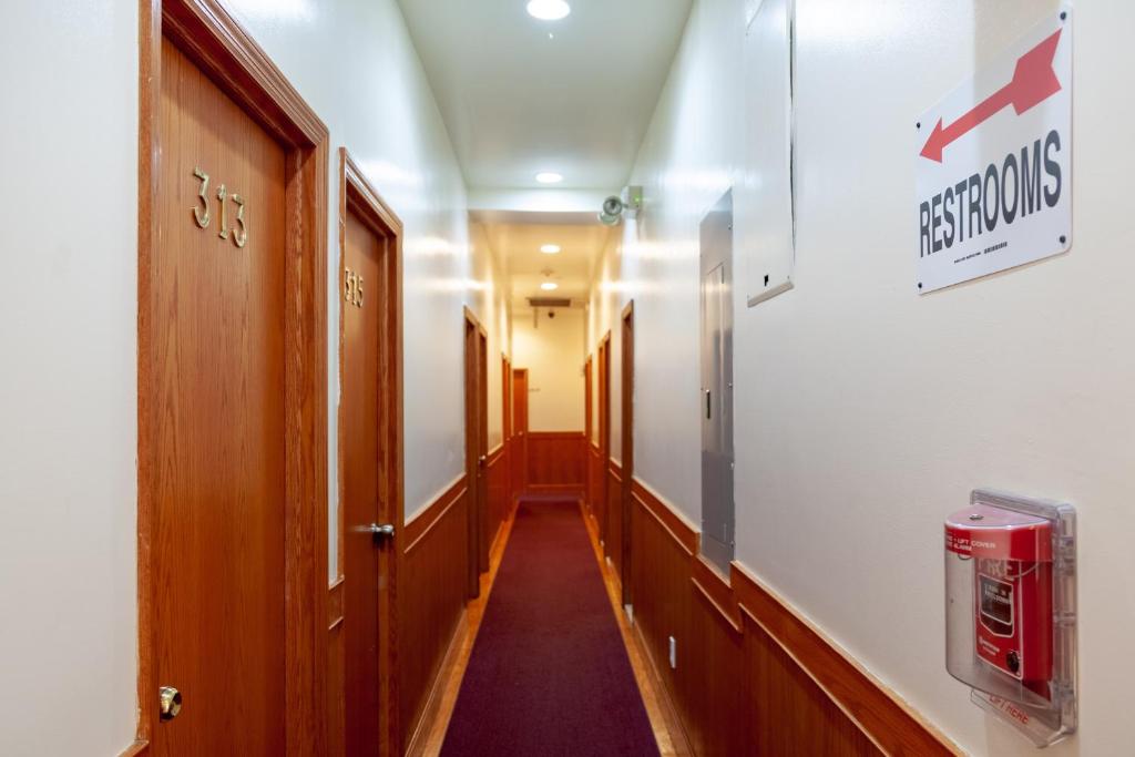 a corridor of a hospital hallway with a sign on the wall at U.S. Pacific Hotel in New York