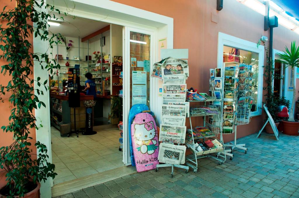a store with a skateboard leaning against a wall at New Camping Le Tamerici in Marina di Cecina