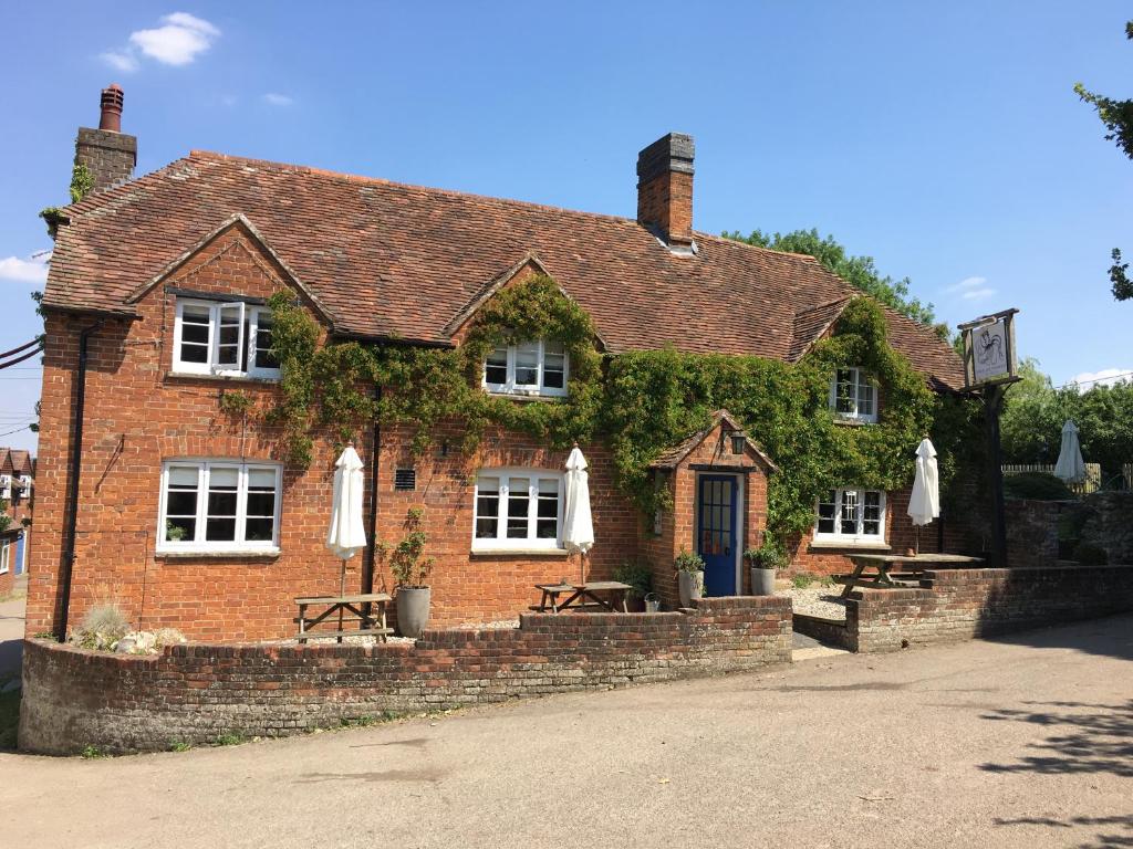 a brick building with ivy growing on it at The Hundred of Ashendon in Waddesdon