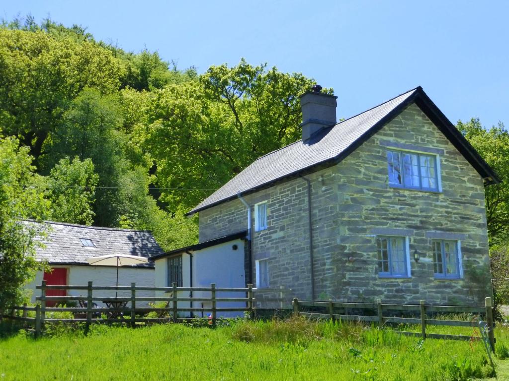 una vieja casa de piedra en medio de un campo en Dolmurgoch Snowdonia Cottage en Dolwyddelan