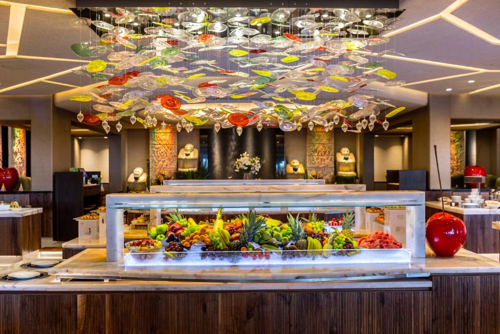 a buffet in a hotel with a display of vegetables at Four Seasons Hotel in Limassol
