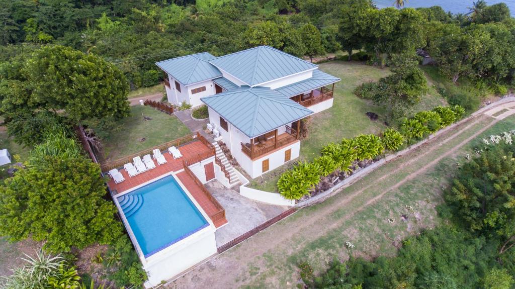 an aerial view of a house with a swimming pool at Two Bays Beach Villa, Apartment, and Studios in Crochu