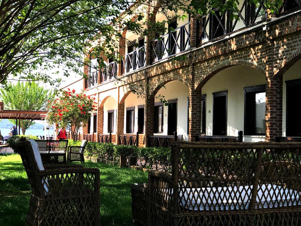 a group of benches in front of a building at Cunda Deniz Hotel in Ayvalık