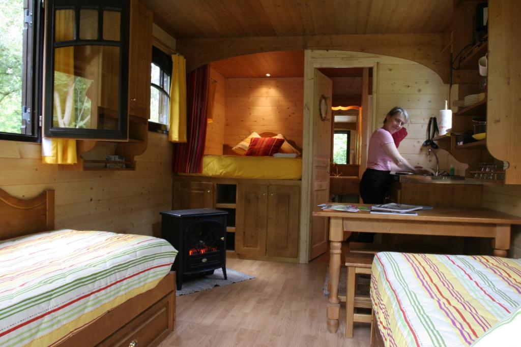 a woman standing in the kitchen of a tiny house at La Maison de l'Omignon in Vermand