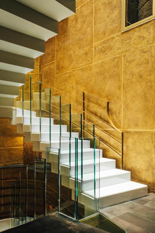 a staircase with glass railings in a building at Hotel Bagués, a Small Luxury Hotel of the World in Barcelona