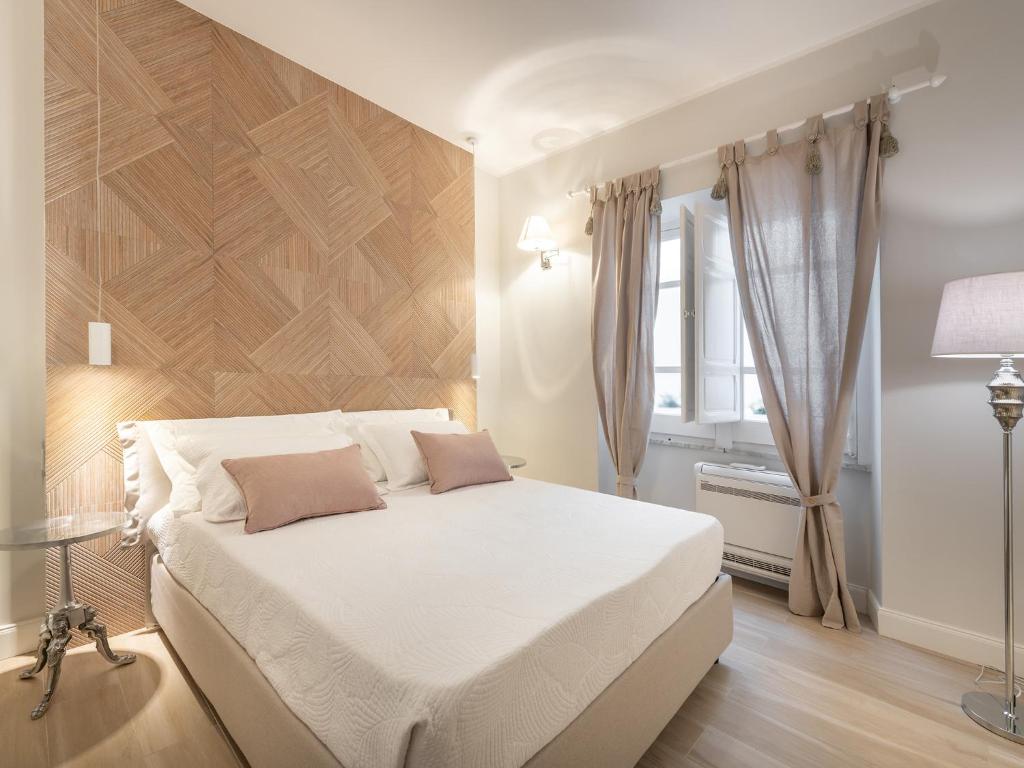 Postel nebo postele na pokoji v ubytování AQUAMADRE Suites