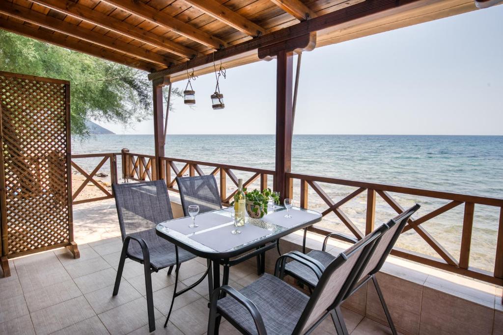 a table and chairs on a patio overlooking the ocean at Sunrise Studio in Skala Kallirachis