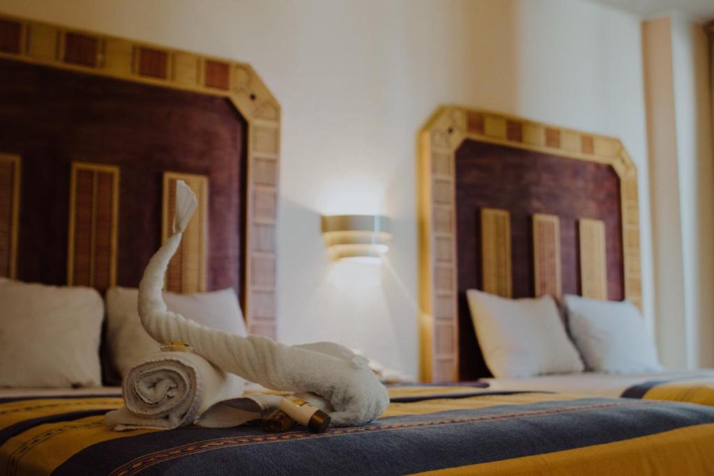 Postel nebo postele na pokoji v ubytování Hotel Ambassador Mérida