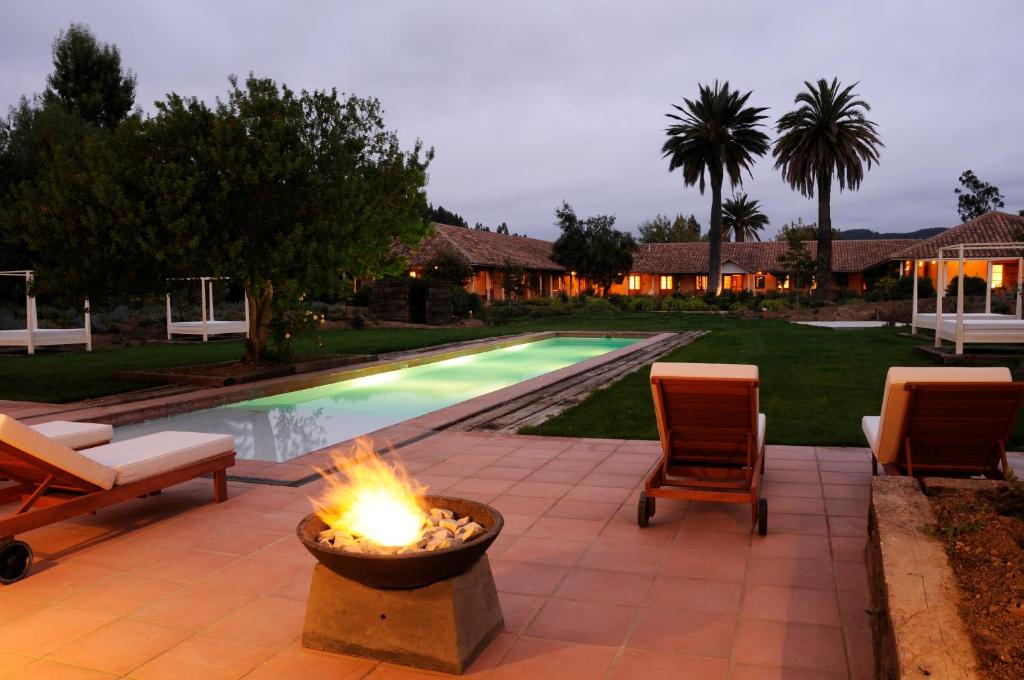 a backyard with a fire pit and a swimming pool at La Casona At Matetic Vineyards in Lagunillas