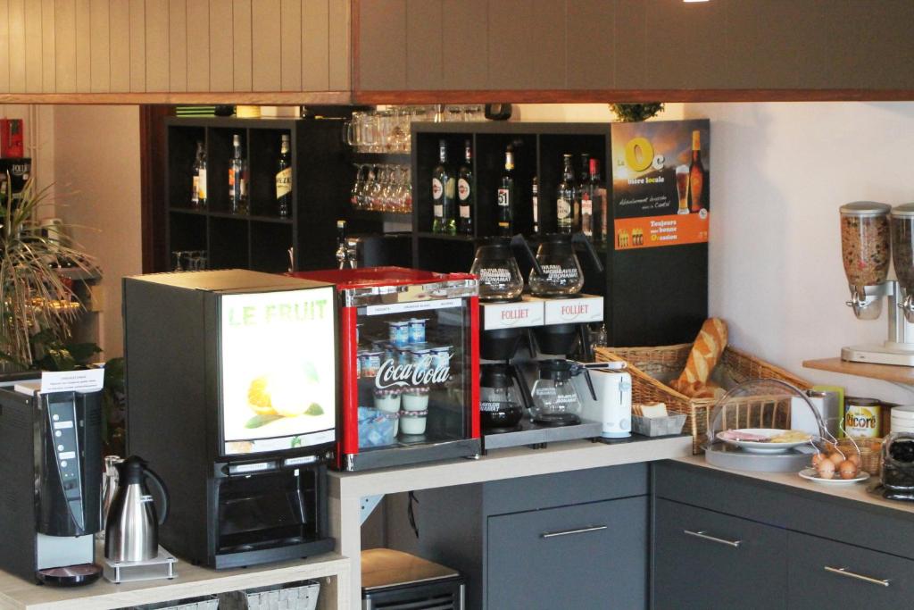 a coffee shop with a drink dispenser and a machine at Hôtel des Chazes in Saint-Jacques-des-Blats